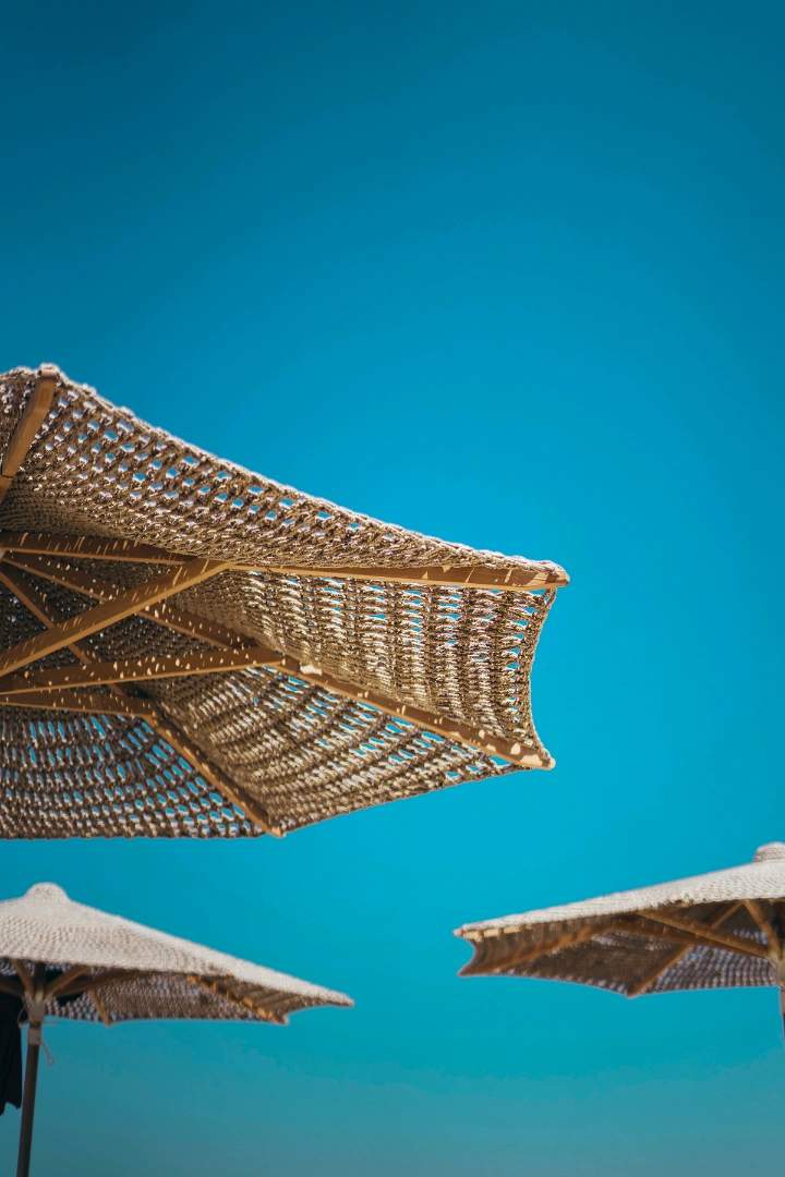 Les parasols autour de la piscine chauffée de l'Ecrin des bois